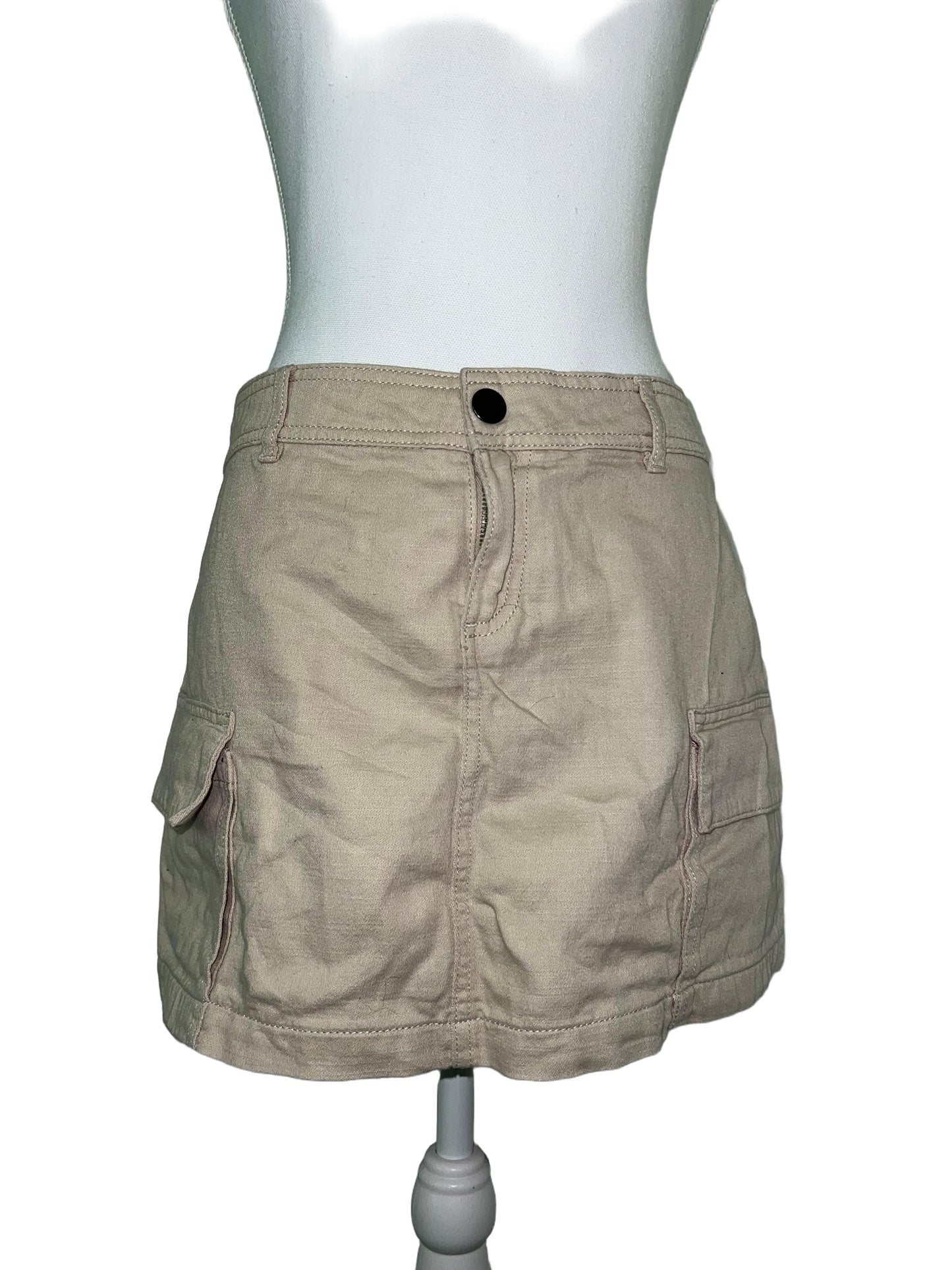 Beige cargo mini skirt, size 14, with practical pockets and a sleek silhouette on a mannequin.